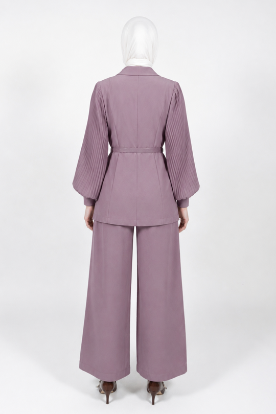 A mauve-colored two-piece suit with a pleated long-sleeve blazer and matching wide-leg trousers, shown from the back on a mannequin against a white studio background.