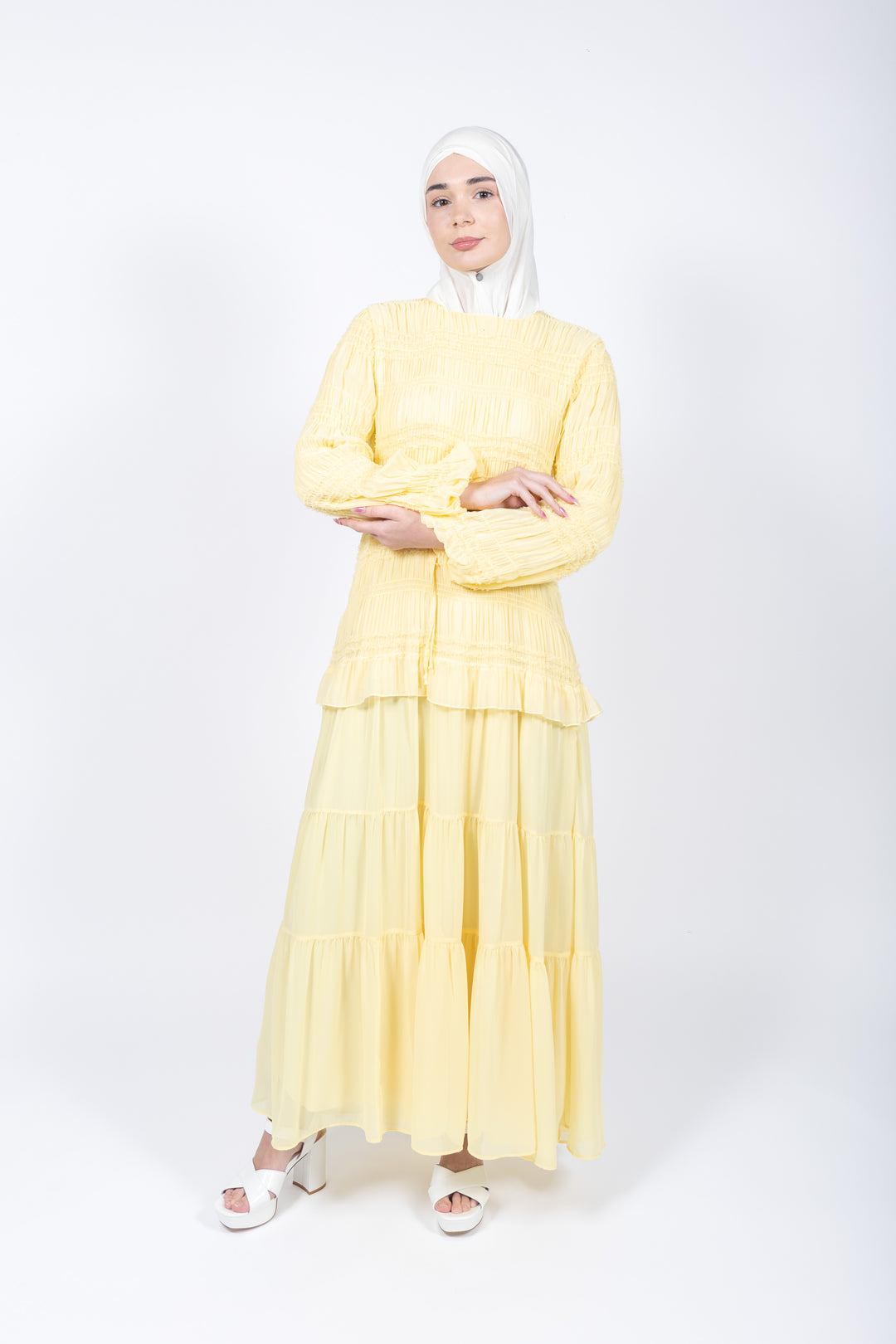 Woman wearing a yellow outfit on a white background