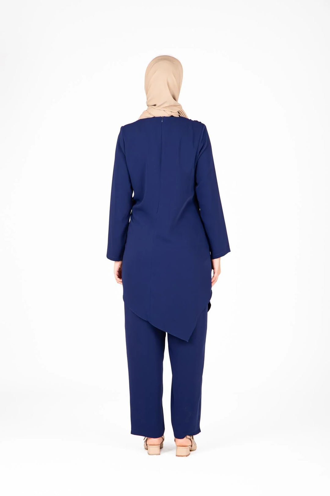 Woman wearing a blue outfit with a hijab on a white background